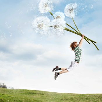 Child Holding Giant Dandelions